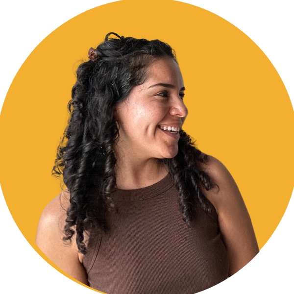 Eli, smiling, in front of a yellow circle